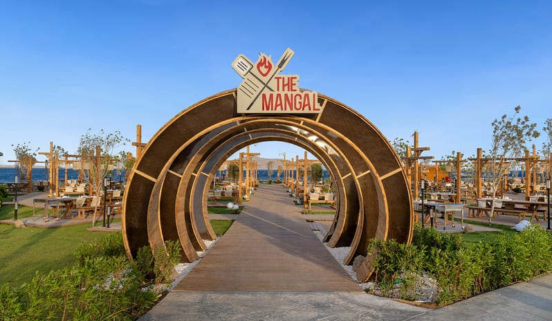 The Managal Circular wooden archway entrance to The Mangal outdoor barbecue restaurant at Rixos Radamis Sharm El Sheikh by Kenwood Travel