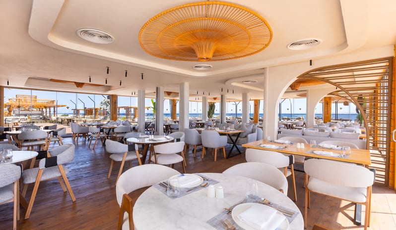 People's Restaurant Modern indoor dining area with sea views and woven bamboo ceiling installations at Rixos Radamis Sharm El Sheikh by Kenwood Travel