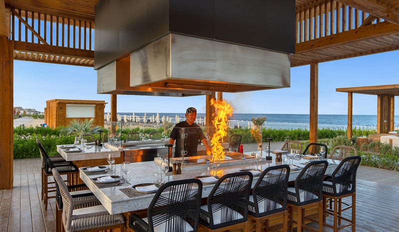 Teppanyaki Live cooking fire show by a chef at an outdoor beachfront at Rixos Radamis Sharm El Sheikh by Kenwood Travel