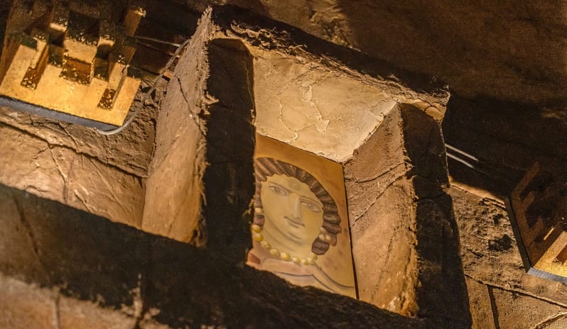 Caligula Hot Rock A replica classical fresco painting of a face displayed within a hollow stone block niche on a decorative wall at Savoy Sharm El Sheikh by Kenwood Travel