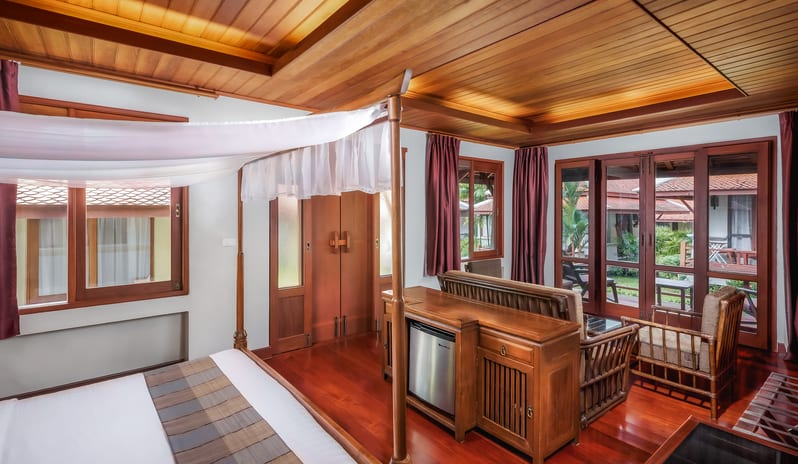 Oriental Villa bedroom with four-poster bed and tropical wood finishes at Khaolak Laguna Resort by Kenwood Travel