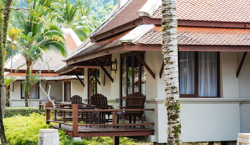 Oriental Villa exterior terrace with wooden deck chairs at Khaolak Laguna Resort by Kenwood Travel
