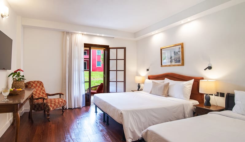 Family Interconnecting Apartment with Veranda modern bedding, wooden desk, and outdoor garden access at Grecotel LUXME Costa Botanica by Kenwood Travel