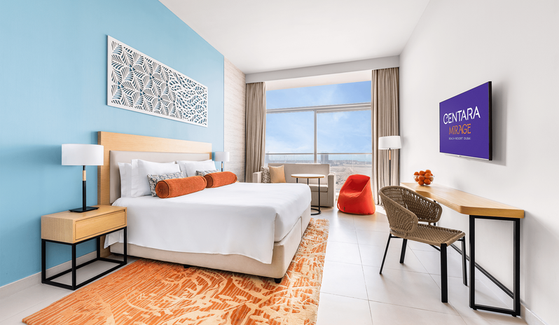 Superior Room King modern interior with blue accent wall and sea view window at Centara Mirage Beach Resort Dubai by Kenwood Travel