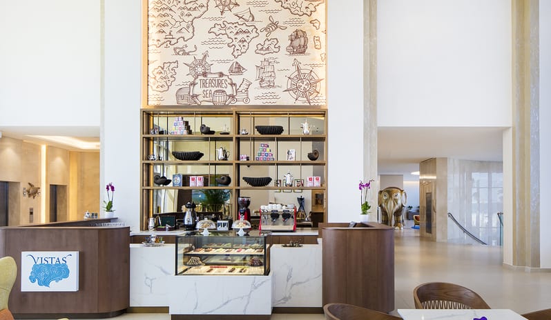 Vistas Lobby Bar cafe design with custom wood cabinetry, marble counters, high ceilings, and coastal-themed decorative accents at Centara Mirage Beach Resort Dubai by Kenwood Travel