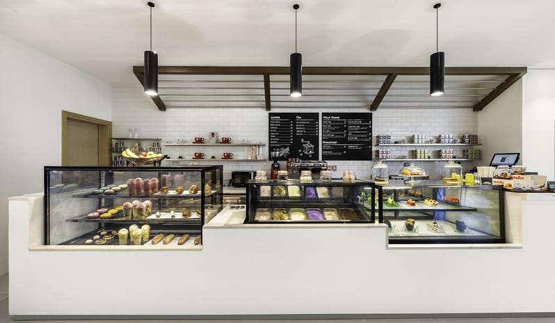 Zing Bright hotel bakery counter showcasing fresh pastries, croissants, donuts, and a colorful ice cream display with minimalist pendant lighting at Centara Mirage Beach Resort Dubai by Kenwood Travel