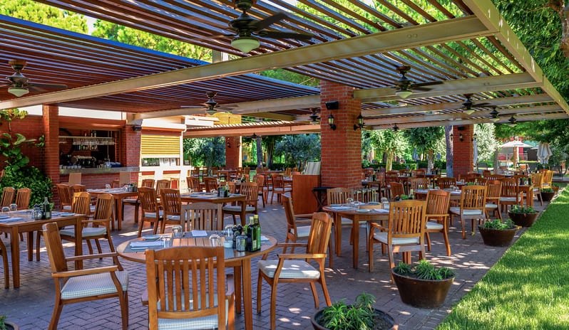 La Trattoria Romana A La Carte Restaurant outdoor restaurant seating and brick terrace design at Gloria Serenity Resort by Kenwood Travel