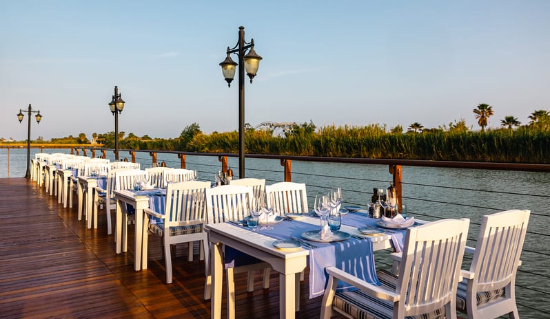 River Landing A La Carte Restaurant outdoor waterfront restaurant dining tables and deck at Gloria Serenity Resort by Kenwood Travel