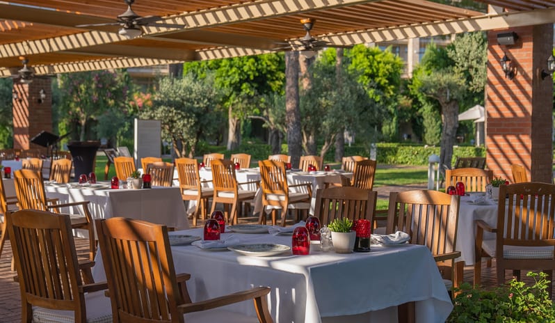 La Trattoria Romana A La Carte Restaurant outdoor restaurant seating and brick terrace design at Gloria Serenity Resort by Kenwood Travel