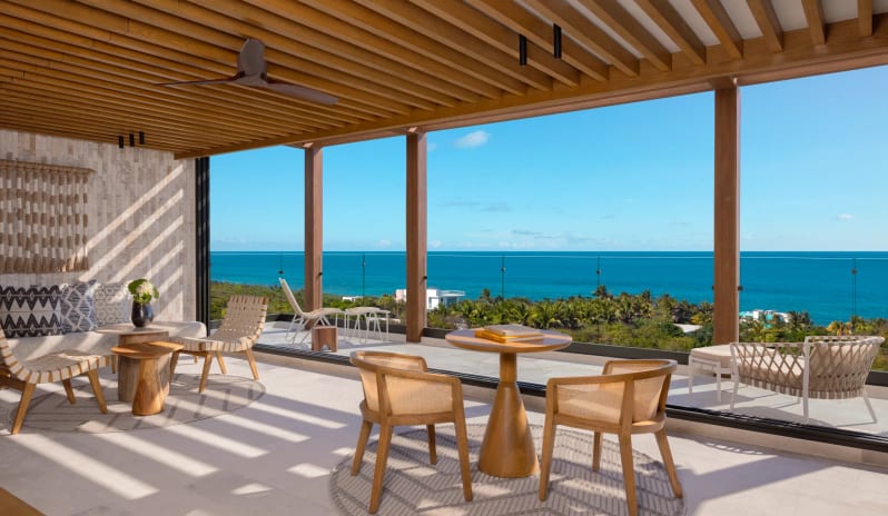 Honeymoon Suite Ocean View outdoor terrace lounge with premium patio furniture and a panoramic ocean view at Impression Isla Mujeres by Secrets by Kenwood Travel
