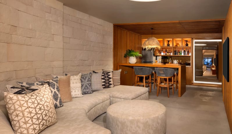 Paramount Suite Ocean Front living room and private bar counter at Impression Isla Mujeres by Secrets by Kenwood Travel
