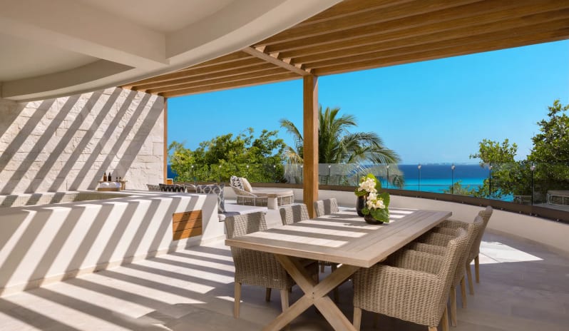 Presidential Suite king suite outdoor dining terrace with panoramic ocean view at Impression Isla Mujeres by Secrets by Kenwood Travel