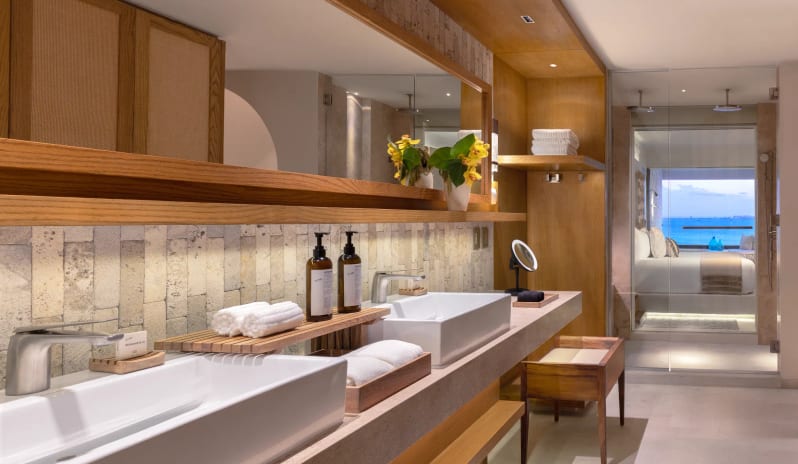 Signature Junior Suite Double Ocean View W/ Hot Tu bathroom with double vanity sinks and modern stone finishes at Impression Isla Mujeres by Secrets by Kenwood Travel