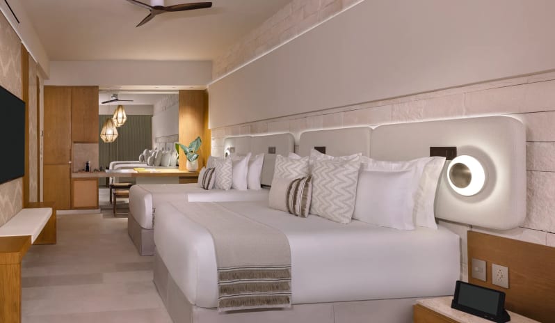 Junior Suite Double two double beds and luxury neutral-toned decor at Impression Isla Mujeres by Secrets by Kenwood Travel