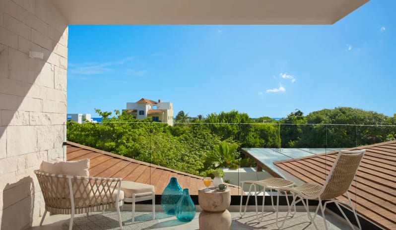 Junior Suite Doublebalcony with outdoor seating area and distant ocean views at Impression Isla Mujeres by Secrets by Kenwood Travel