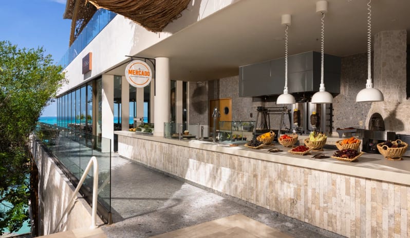 Mercado buffet station and open kitchen area with a scenic ocean view at Impression Isla Mujeres by Secrets by Kenwood Travel