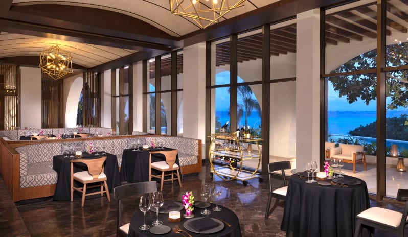 Wildfire Grill dining area with elegant seating and panoramic ocean views at Impression Isla Mujeres by Secrets by Kenwood Travel
