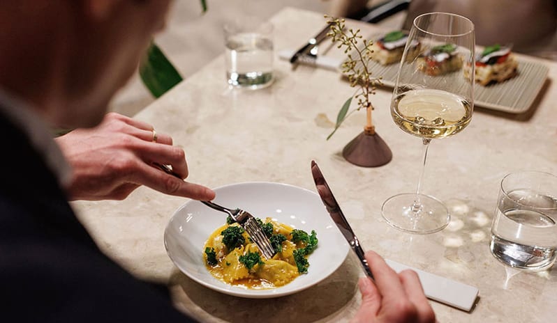 JAZ by Ana Roš Diner enjoying fresh ravioli pasta served with a glass of white wine at Pical Resort, Valamar Collection by Kenwood Travel