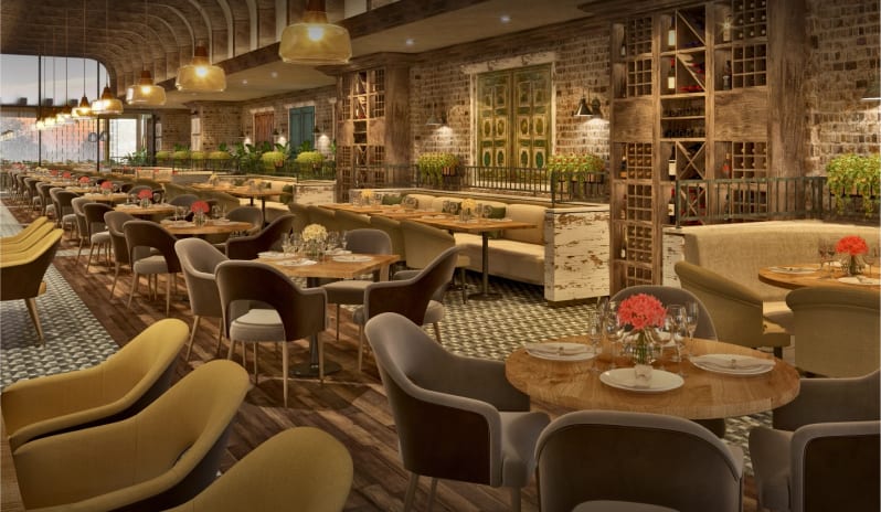 Tavola wooden tables, exposed brick walls, built-in wine racks, and plush armchairs at Moon Palace The Grand Punta Cana by Kenwood Travel