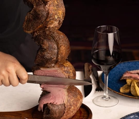 Carvão Chef carving grilled meat from a skewer at Moon Palace The Grand Punta Cana by Kenwood Travel