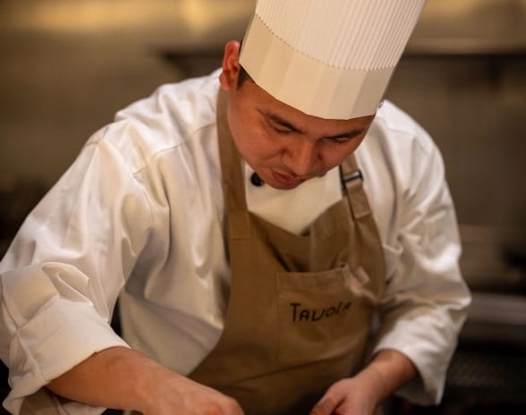 Tavola Chef garnishing a pasta dish at Moon Palace The Grand Punta Cana by Kenwood Travel