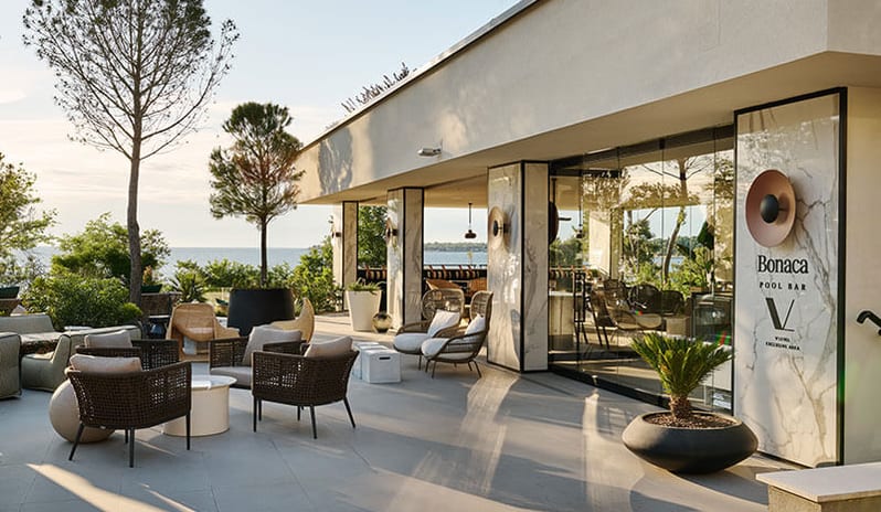 Bonaca Pool Bar Outdoor patio seating area with ocean view at Pical Resort, Valamar Collection by Kenwood Travel