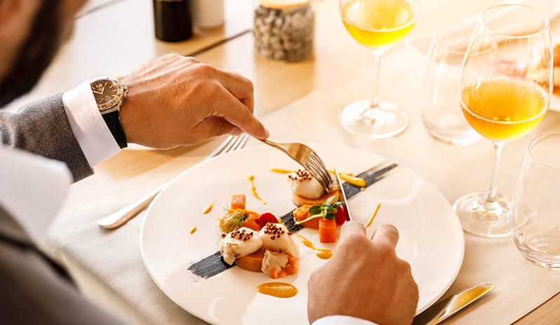 Miramare Restaurant by Fratelli Cerea SGuest dining on a gourmet plated entree with white wine at Pical Resort, Valamar Collection by Kenwood Travel