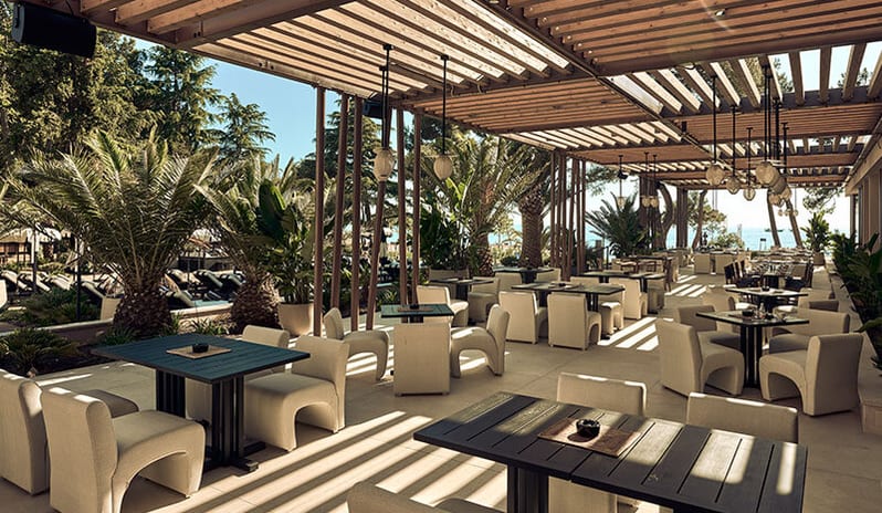 Purobeach Poreč Shaded outdoor dining area under a wooden pergola at Pical Resort, Valamar Collection by Kenwood Travel