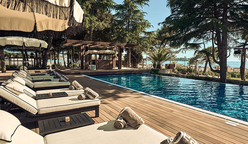 Purobeach Poreč Poolside lounge chairs with umbrellas at Pical Resort, Valamar Collection by Kenwood Travel