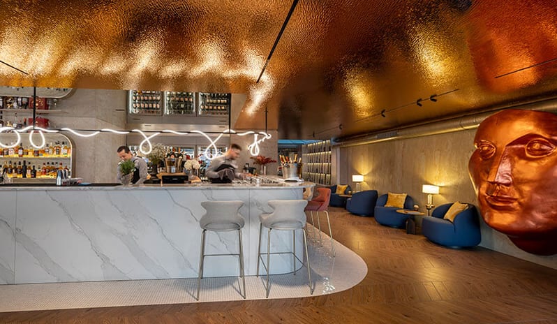Pical rooftop bar by Laurent Perrier shimmering copper ceiling tiles, elegant armchairs, decorative wall sculptures, and panoramic ocean views at Pical Resort, Valamar Collection by Kenwood Travel