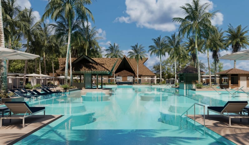 Unique Day Club Tropical resort swimming pool surrounded by palm trees and sun loungers at Moon Palace The Grand Punta Cana by Kenwood Travel