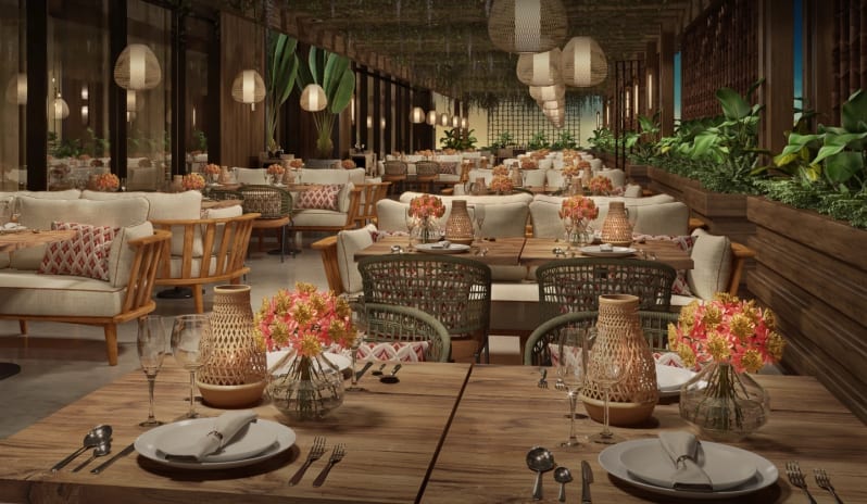 Casa Macao Luxury dining room with wooden furnishings, tropical plants, and rattan pendant lighting at Moon Palace The Grand Punta Cana by Kenwood Travel