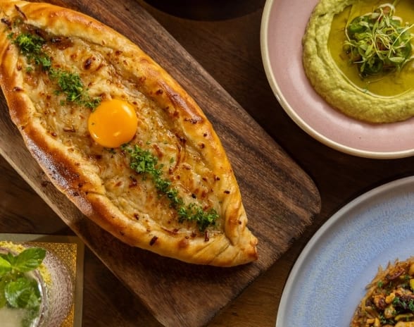 Habibi Middle Eastern cheese pide flatbread and colorful mezze dips served family style at Moon Palace The Grand Punta Cana by Kenwood Travel