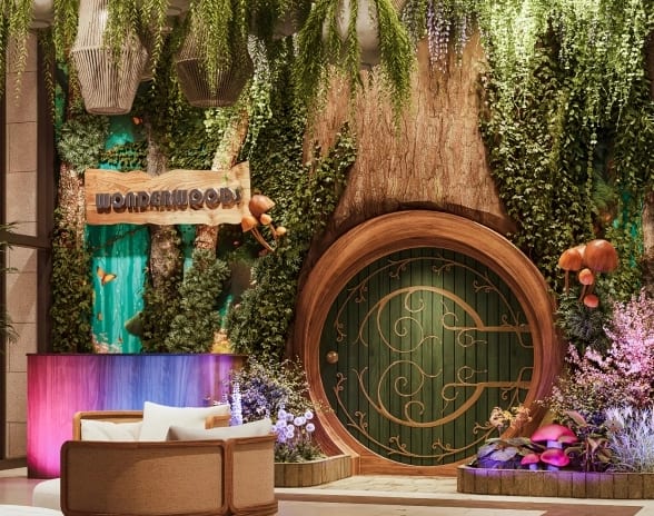 Wonderwoods Enchanted forest lounge entrance with a circular wooden door and hanging foliage at Moon Palace The Grand Punta Cana by Kenwood Travel