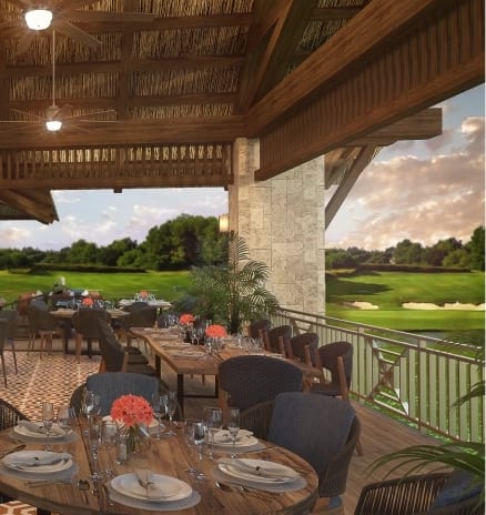 19th Hole Golf course clubhouse patio dining with thatched roof and scenic green views at Moon Palace The Grand Punta Cana by Kenwood Travel