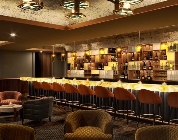 Speakeasy Bar Illuminated cocktail bar counter lined with orange velvet bar stools and lounge seating at Moon Palace The Grand Punta Cana by Kenwood Travel