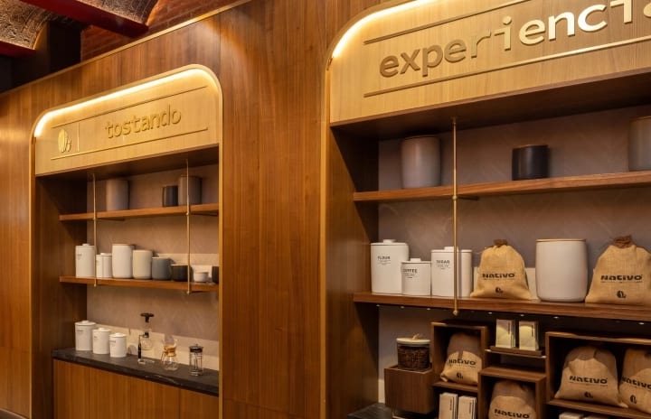 Nativo Casa De Tueste Wooden display shelving with coffee roasting equipment and branded burlap coffee bags at Moon Palace The Grand Punta Cana by Kenwood Travel
