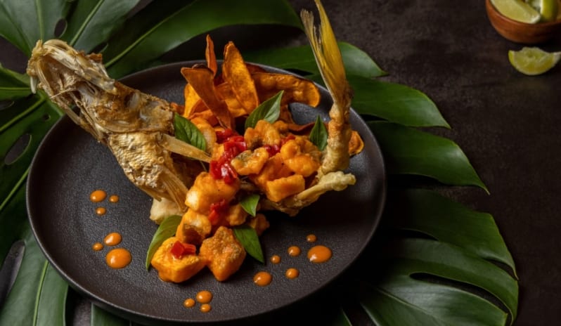 Madremía Gourmet crispy fried whole fish topped with red chilies and served with plantain chips at Moon Palace The Grand Punta Cana by Kenwood Travel