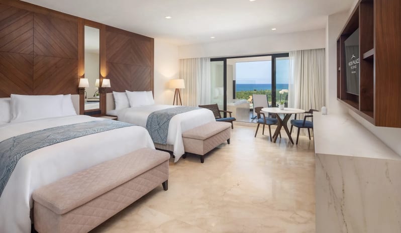Grand Superior Deluxe Ocean View modern wood finishes and private balcony overlooking the ocean at Moon Palace The Grand Punta Cana by Kenwood Travel