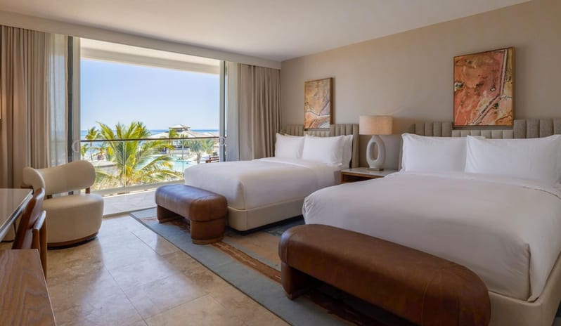 Deluxe Ocean View Queen Beds, Balcony double queen guest bedroom with private balcony overlooking the resort pool and ocean at Salterra, A Luxury Collection Resort & Spa, South Caicos by Kenwood Travel