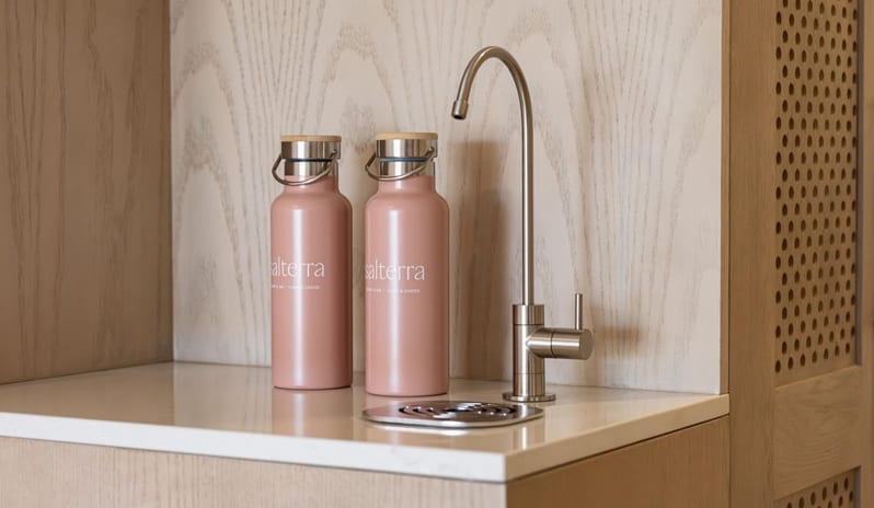 Deluxe Ocean View Queen Beds, Balcony Salterra resort water refill dispenser with reusable pink water bottles at Salterra, A Luxury Collection Resort & Spa, South Caicos by Kenwood Travel