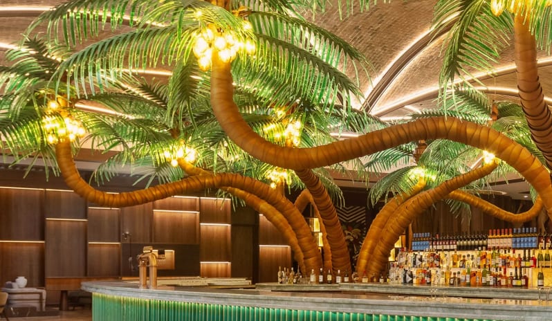 Lobby Bar Terrace Curved green lobby bar with sculptural illuminated palm trees at Moon Palace The Grand Punta Cana by Kenwood Travel