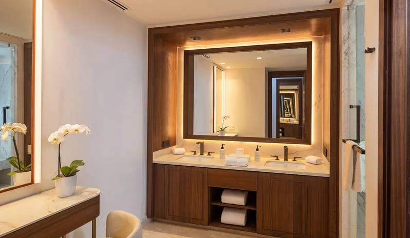Grand Superior Deluxe Golf View bathroom with illuminated double vanity and makeup table at Moon Palace The Grand Punta Cana by Kenwood Travel