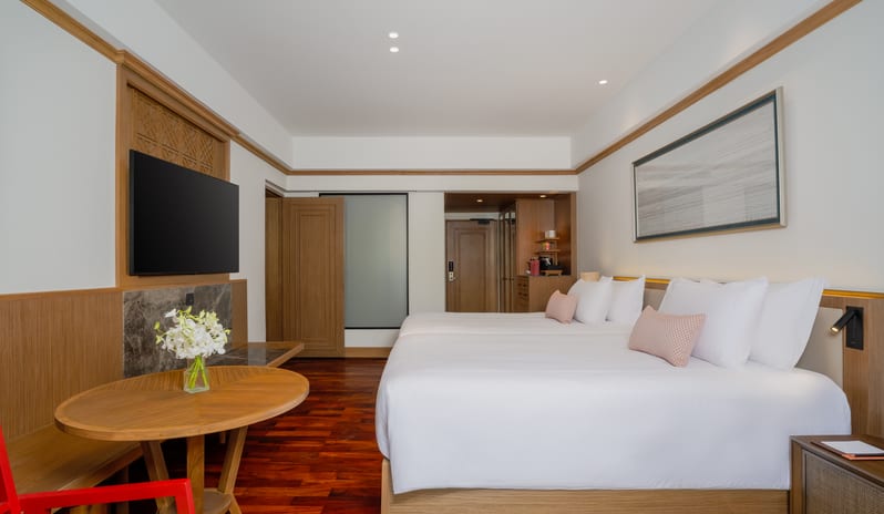 Club Two Bedroom Family Suite two beds and a wall-mounted TV in the Club Two Bedroom Family Suite at Anantara Hua Hin Resort  by Kenwood Travel