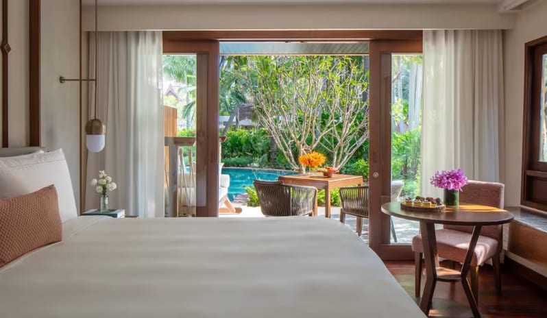 Deluxe Pool Access king bed and glass doors leading directly to a private patio and resort swimming pool at Anantara Hua Hin Resort  by Kenwood Travel