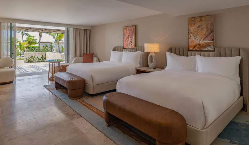 Salterra, A Luxury Collection Resort & Spa, South Caicos-Grand Deluxe Ocean View Queen Beds Lanai Patio Spacious double queen hotel room with modern decor and a patio leading outdoors at Anantara Hua Hin Resort  by Kenwood Travel