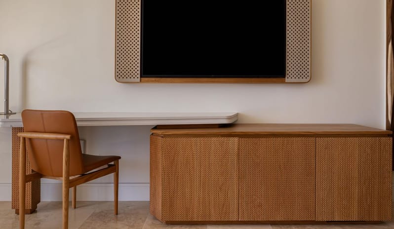 Salterra, A Luxury Collection Resort & Spa, South Caicos-Grand Deluxe Ocean View Queen Beds Lanai Patio In-room hotel workspace with a wooden desk, leather armchair, and wall-mounted television at Anantara Hua Hin Resort  by Kenwood Travel