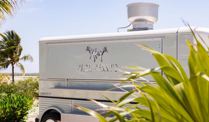 Jack & Jenny's food truck at a tropical resort surrounded by palm trees at Salterra, A Luxury Collection Resort & Spa, South Caicos by Kenwood Travel