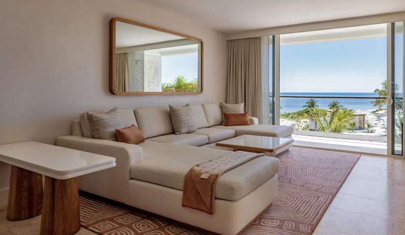 Two Bedroom Ocean View Suite, Top floor, Balcony living room featuring a sectional couch and scenic ocean views from a private balcony at Salterra, A Luxury Collection Resort & Spa, South Caicos by Kenwood Travel