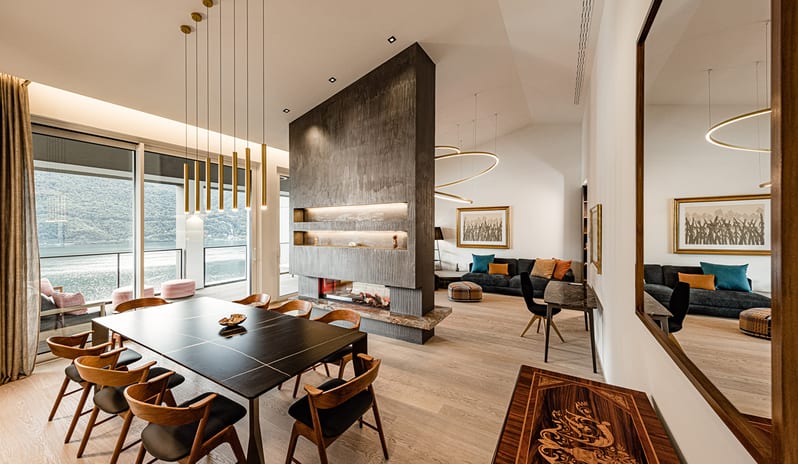Iconic Aria Penthouse Suite Sleek dining area with modern pendant lights and balcony lake views at ARIA Retreat & SPA by Kenwood Travel